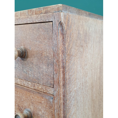 905 - A Heal's limed oak small Chest of Drawers, the top drawer with carved detail above three drawers on ... 