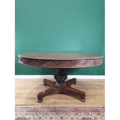 913 - A 19th century Colonial Centre Table with carved and moulded edge, the frieze carved leaves and rose... 