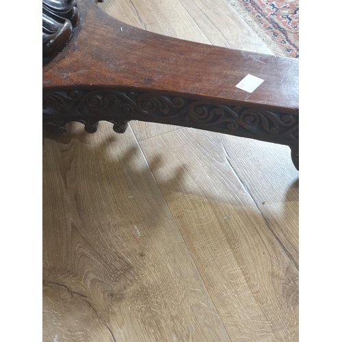 913 - A 19th century Colonial Centre Table with carved and moulded edge, the frieze carved leaves and rose... 