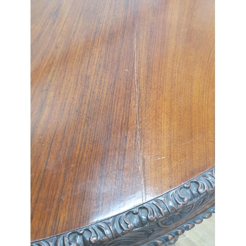 913 - A 19th century Colonial Centre Table with carved and moulded edge, the frieze carved leaves and rose... 