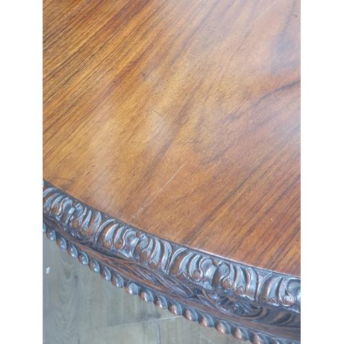 913 - A 19th century Colonial Centre Table with carved and moulded edge, the frieze carved leaves and rose... 