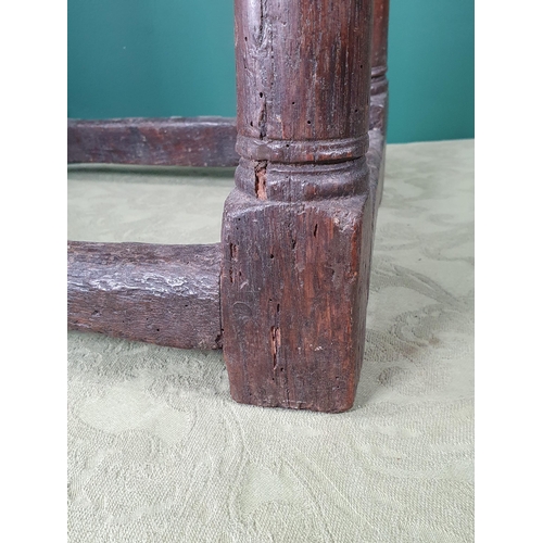 916 - An antique oak Joined Stool with moulded edge to the top and frieze, on turned tapering supports and... 