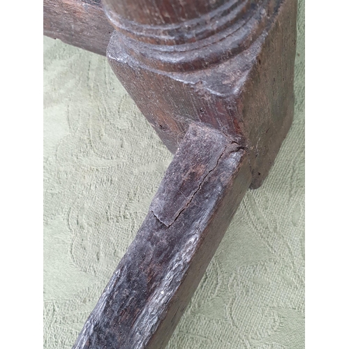 916 - An antique oak Joined Stool with moulded edge to the top and frieze, on turned tapering supports and... 