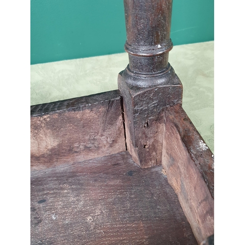 916 - An antique oak Joined Stool with moulded edge to the top and frieze, on turned tapering supports and... 