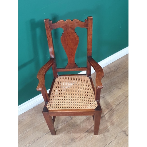 920 - A late 19th Century walnut Child's Elbow Chair with vase splat back, cane panelled seat on squared s... 