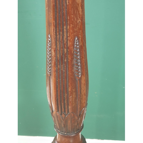 925 - A mahogany Torchere Stand with dished top on octagonal baluster tapering column and carved tripod ba... 