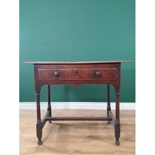 934 - An 18th Century oak Side Table with three piece top, single fitted drawer, above a shaped frieze, on... 