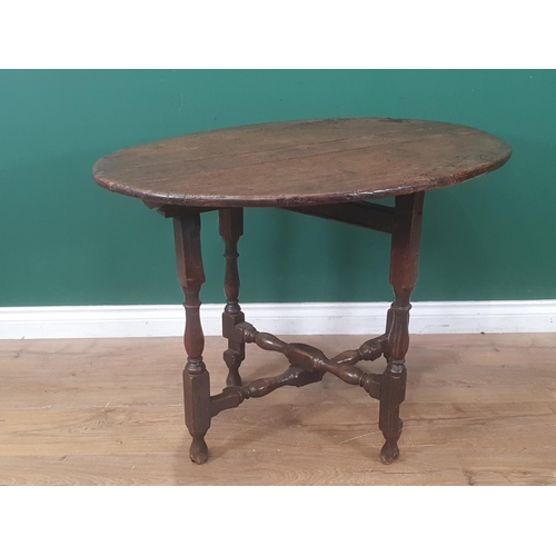 937 - A late 17th Century Coaching Table with elm oval top raised upon oak baluster and squared supports 3... 