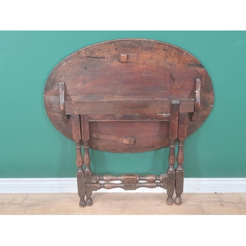 937 - A late 17th Century Coaching Table with elm oval top raised upon oak baluster and squared supports 3... 