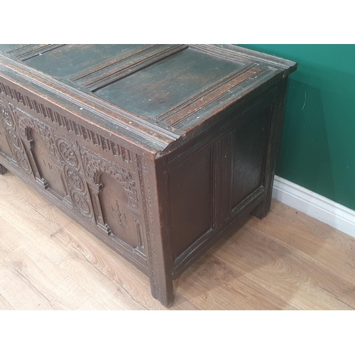 938 - An early 17th Century oak Coffer with sunken three panel lid above nulled frieze and three arched pa... 