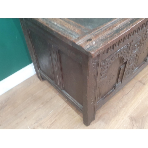 938 - An early 17th Century oak Coffer with sunken three panel lid above nulled frieze and three arched pa... 