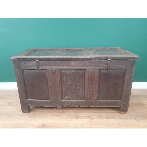 938 - An early 17th Century oak Coffer with sunken three panel lid above nulled frieze and three arched pa... 