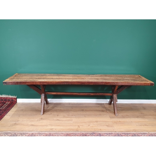 939 - An antique oak long Tavern Table with thick three-plank cleated top on cross frame supports with con... 