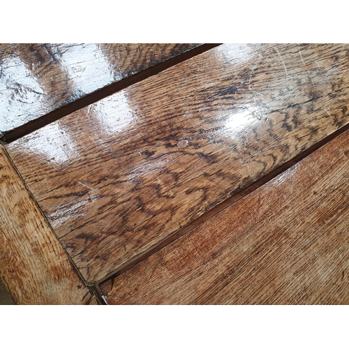 939 - An antique oak long Tavern Table with thick three-plank cleated top on cross frame supports with con... 