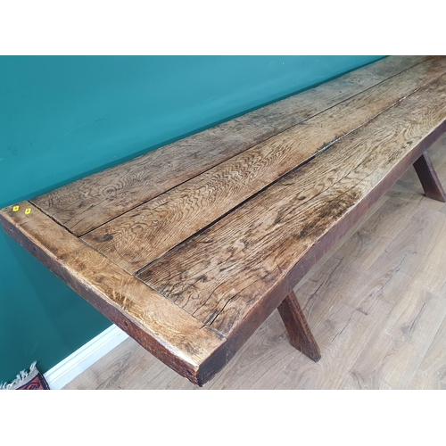 939 - An antique oak long Tavern Table with thick three-plank cleated top on cross frame supports with con... 