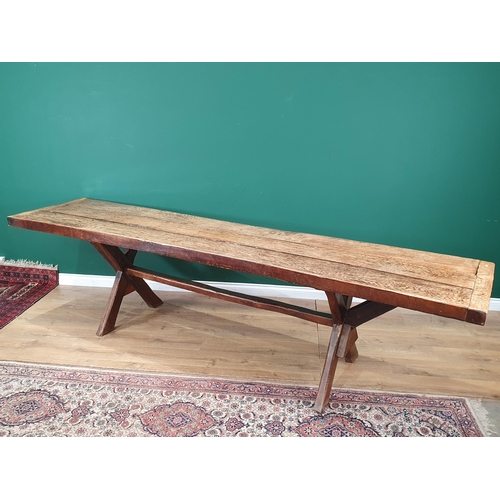 939 - An antique oak long Tavern Table with thick three-plank cleated top on cross frame supports with con... 