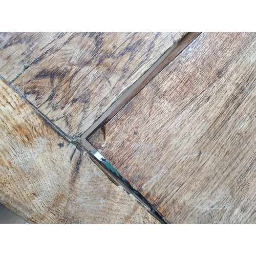 939 - An antique oak long Tavern Table with thick three-plank cleated top on cross frame supports with con... 