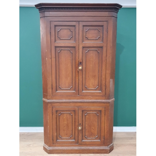 941 - A George III scumbled pine double Corner Cupboard with dentil frieze above two pairs of panelled doo... 