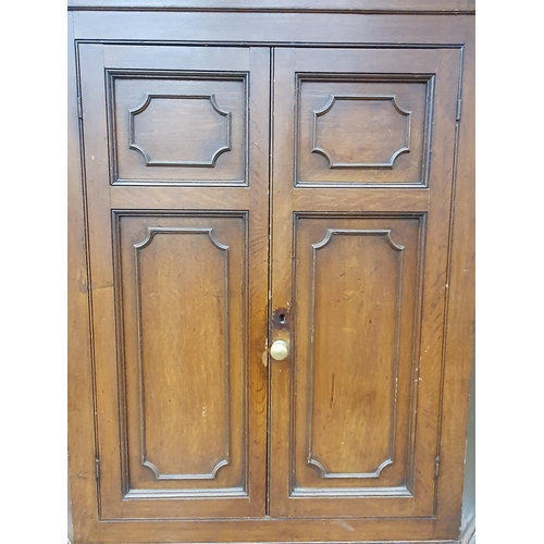 941 - A George III scumbled pine double Corner Cupboard with dentil frieze above two pairs of panelled doo... 