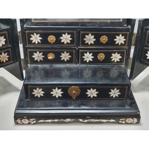 943 - An Oriental Cabinet fitted assorted small drawers and a folding mirror, decorated chinoiserie figure... 