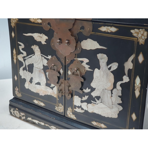 943 - An Oriental Cabinet fitted assorted small drawers and a folding mirror, decorated chinoiserie figure... 