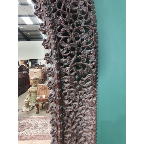 945 - A large impressive Burmese carved arched Mirror, with finely  pierced and carved frame of flowers an... 