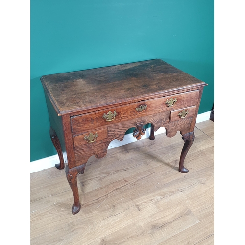 947 - An 18th Century oak Lowboy with moulded top above three drawers on a shaped frieze, raised on cabrio... 