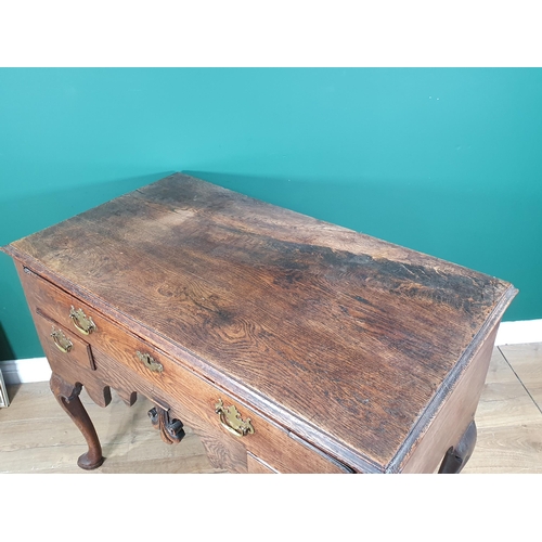 947 - An 18th Century oak Lowboy with moulded top above three drawers on a shaped frieze, raised on cabrio... 