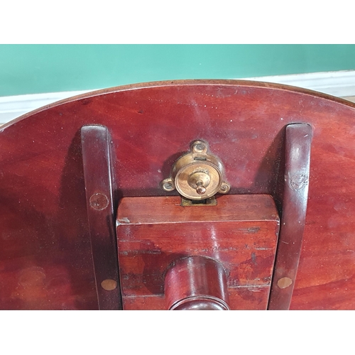 955 - An early 19th Century mahogany tilt top Table with oval top on slender baluster column and reeded do... 