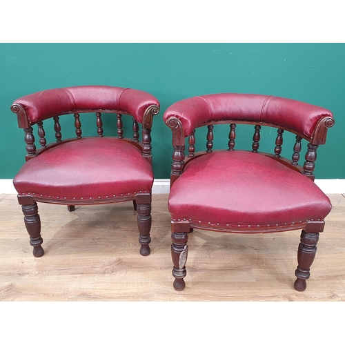 961 - A pair of mahogany and upholstered Library Chairs with carved backs and turned front supports, label... 