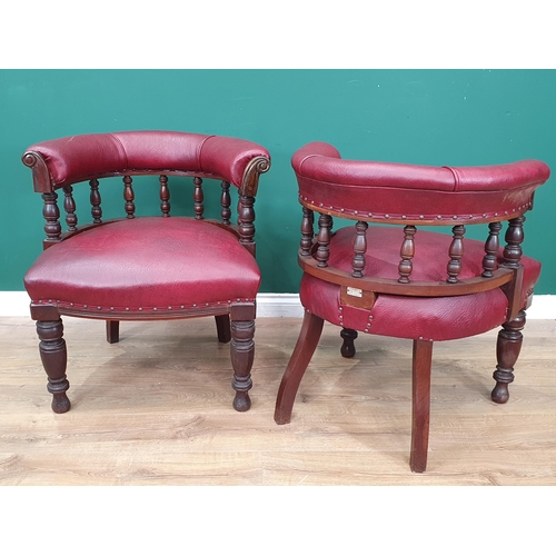 961 - A pair of mahogany and upholstered Library Chairs with carved backs and turned front supports, label... 