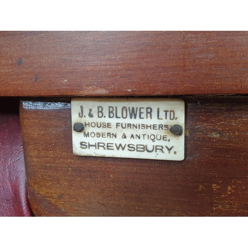 961 - A pair of mahogany and upholstered Library Chairs with carved backs and turned front supports, label... 