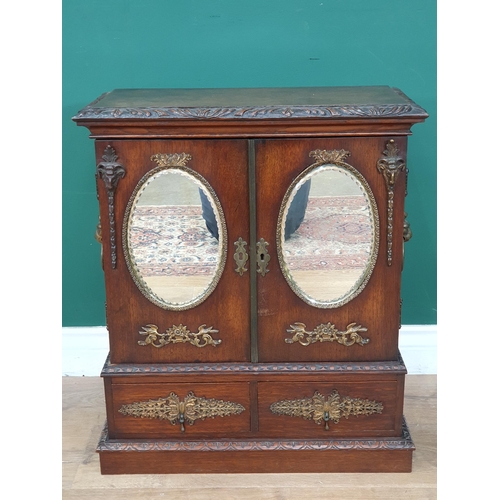 962 - An oak table top Cabinet with pair of doors set oval mirror panels, above two drawers, 1ft 11in H x ... 