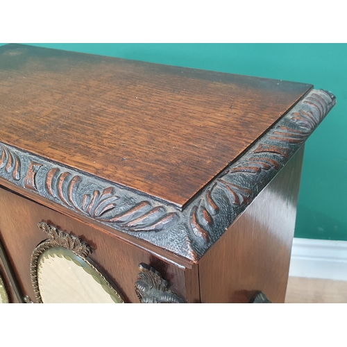 962 - An oak table top Cabinet with pair of doors set oval mirror panels, above two drawers, 1ft 11in H x ... 