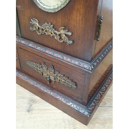 962 - An oak table top Cabinet with pair of doors set oval mirror panels, above two drawers, 1ft 11in H x ... 