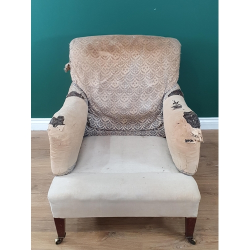 966 - A Howard and Sons Armchair with some blue and white 'H & S' monogrammed ticking, raised on square ta... 