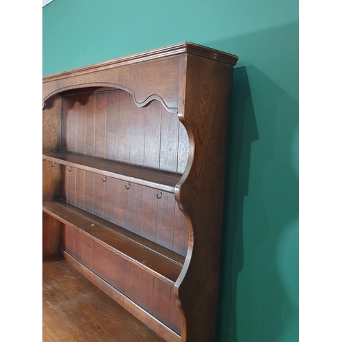 520 - An oak Old Charm Style Dresser and Rack the base fitted two drawers above pair of cupboard doors, 5f... 