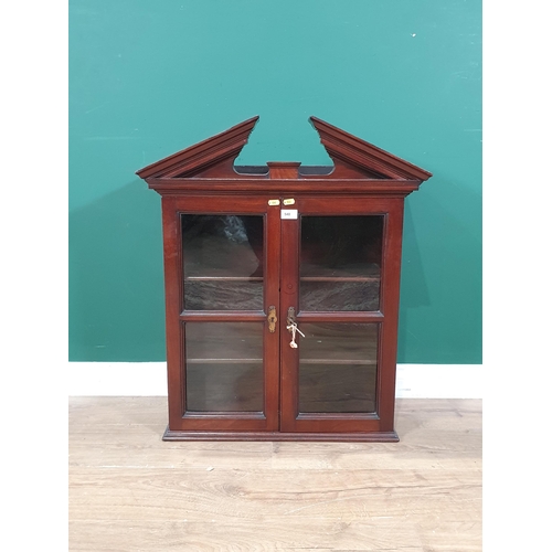 525 - A mahogany glazed door Wall Cabinet enclosing two adjustable shelves with broken pediment cornice, 2... 