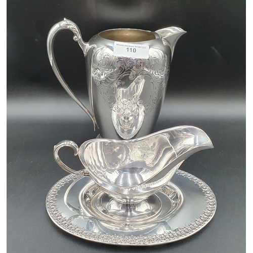 583 - A plated Jug with leafage scroll engraving and a Sauce Boat on Stand with floral border (R2)