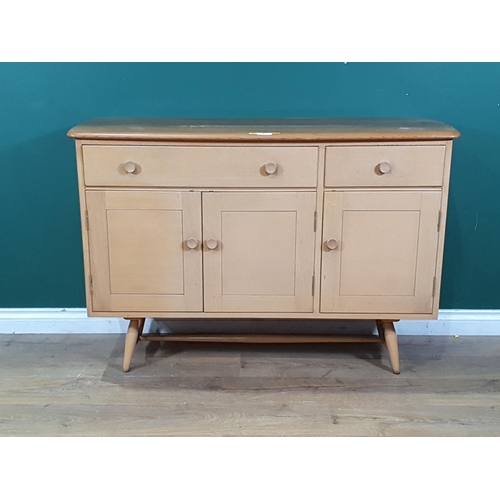 565 - An Ercol Sideboard fitted two frieze drawers above three cupboard doors 3ft 11in W x 2ft 8in H (R4)