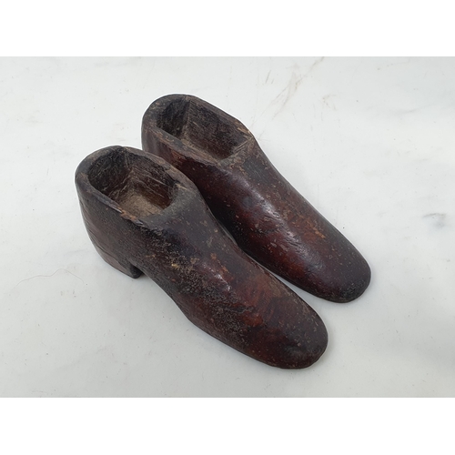 1 - An antique primitive Milking Stool 8 1/4in W x 6 1/2in H and a pair of treen miniature wooden Shoes ... 