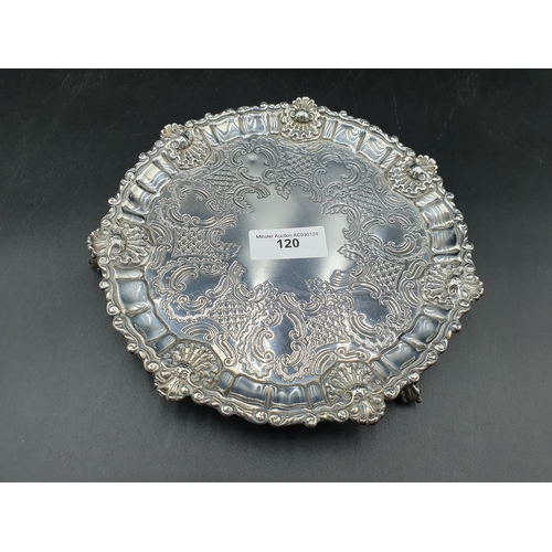 120 - A George IV silver shaped circular Salver with scroll engraving, scallop border on three ball and cl... 