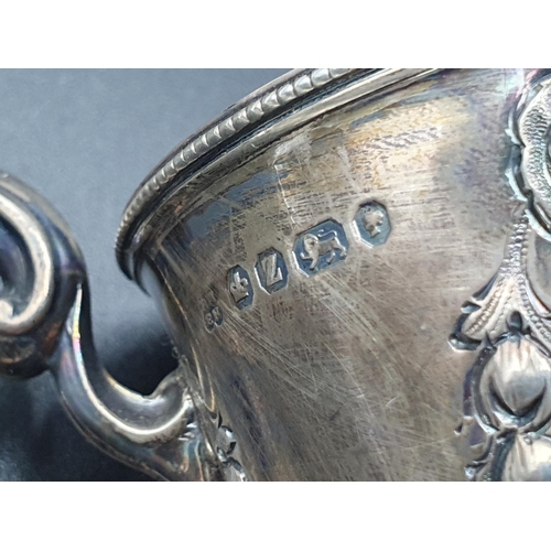 126 - A Victorian silver Christening Mug embossed floral swags, Sheffield 1867, and another, leafage engra... 