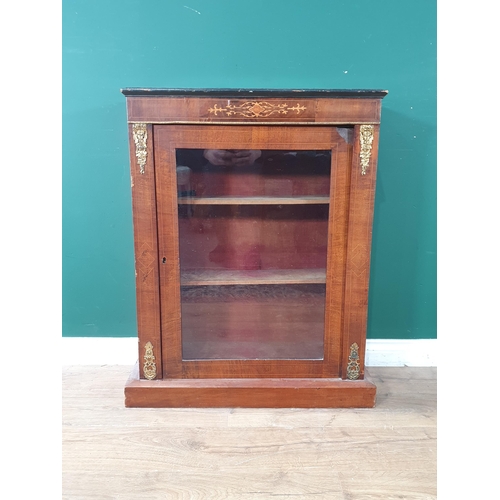 140 - A 19th Century walnut veneered and inlaid Music Cabinet with glazed door enclosing shelves raised on... 