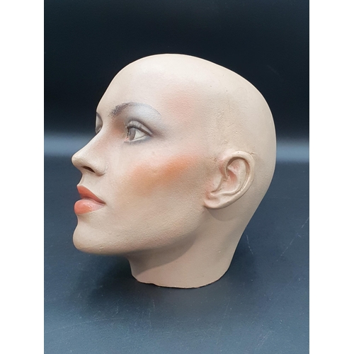 16 - A female Mannikin Head with painted features stamped 'BD9'