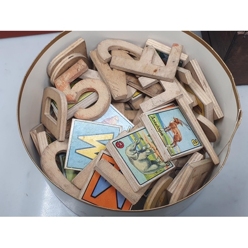 21 - A tub of Alphabet Blocks and Letters, a boxed Puzzle Block Game, a Magic Box and a vintage Biscuit T... 