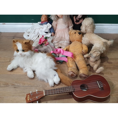 246 - Three Dolls, a soft toy Dog and Rabbit, a Teddy Bear, a 'Fur Real' Cat and a child's Guitar (R6)