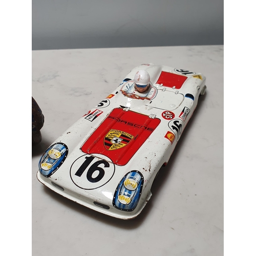 273 - A tinplate clockwork saloon Car and a tinplate Porsche Le Mans Car, both A/F (R8)