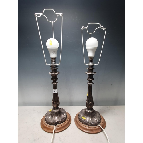 276 - A pair of Victorian silver plated Candlesticks converted to Table Lamps on circular oak bases 1ft 11... 