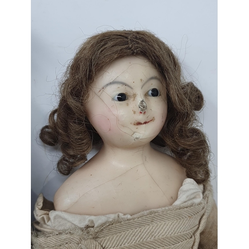 41 - A male Doll with torso mounted on turned handle, three antique wax headed Dolls with fabric bodies a... 